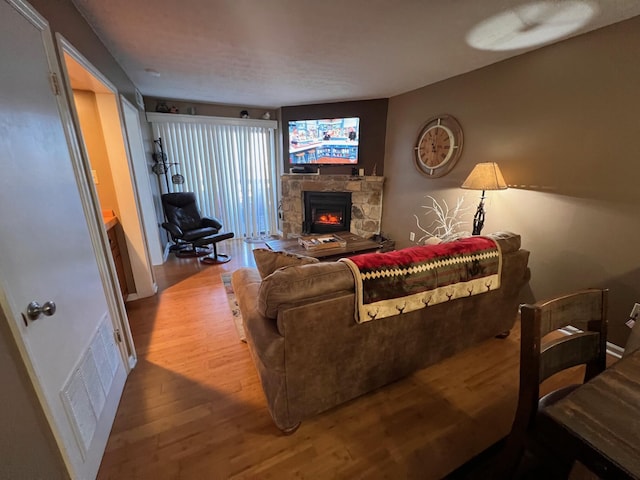 living room with hardwood / wood-style floors and a fireplace