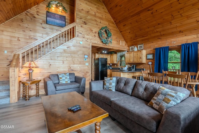 1910 E Mountain View Way, Sevierville, TN 37876 - living area with wooden walls, wooden ceiling, high vaulted ceiling, stairs, and light wood-type flooring