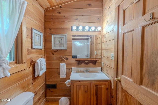 1910 E Mountain View Way, Sevierville, TN 37876 - bathroom with wooden walls, toilet, vanity, and vaulted ceiling
