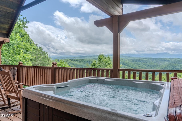 1910 E Mountain View Way, Sevierville, TN 37876 - deck featuring a hot tub, a wooded view, and a mountain view