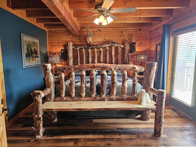 bedroom featuring hardwood / wood-style flooring, ceiling fan, beam ceiling, and multiple windows