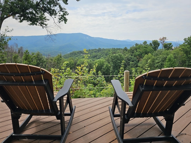 wooden deck with a mountain view