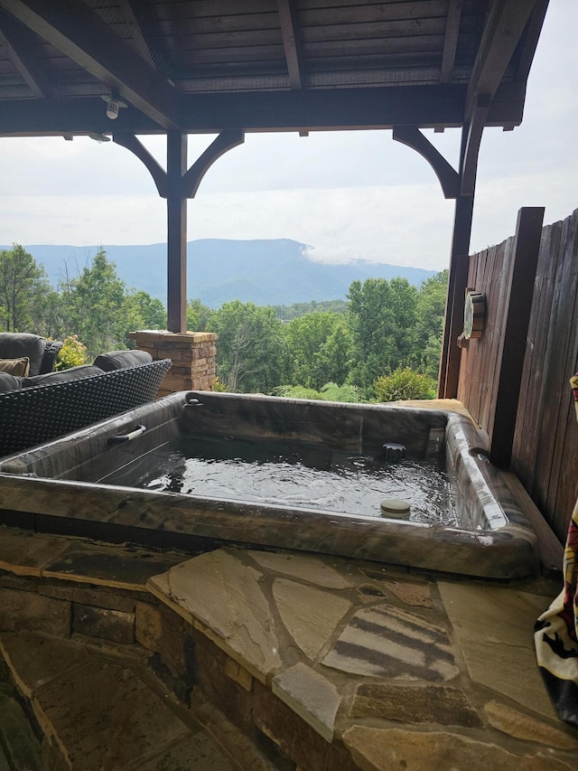 details with a jacuzzi and a mountain view