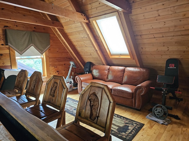 living room featuring hardwood / wood-style floors, wooden ceiling, wooden walls, and lofted ceiling with skylight