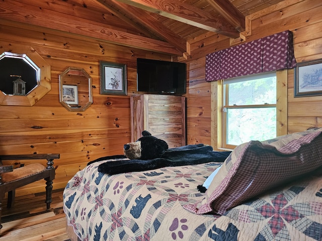 bedroom featuring light wood-type flooring, lofted ceiling with beams, wooden walls, and wooden ceiling