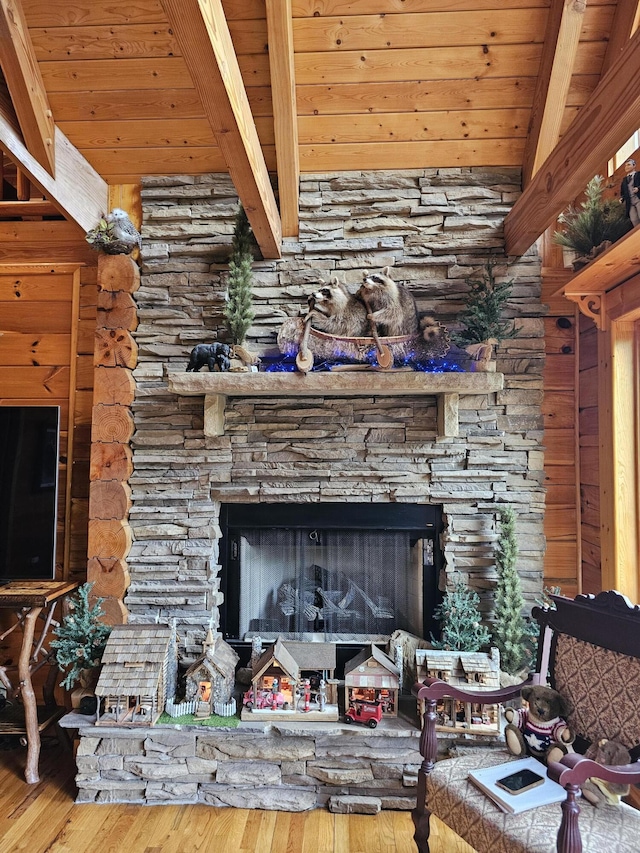 details with a fireplace, wood-type flooring, beamed ceiling, and wood ceiling