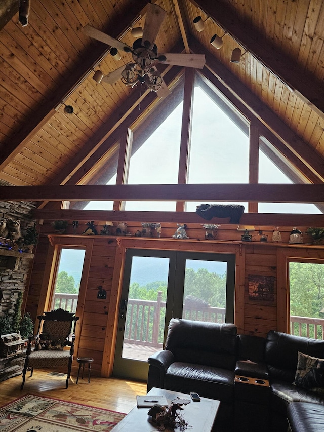 living room with hardwood / wood-style flooring, lofted ceiling with beams, ceiling fan, and wooden ceiling