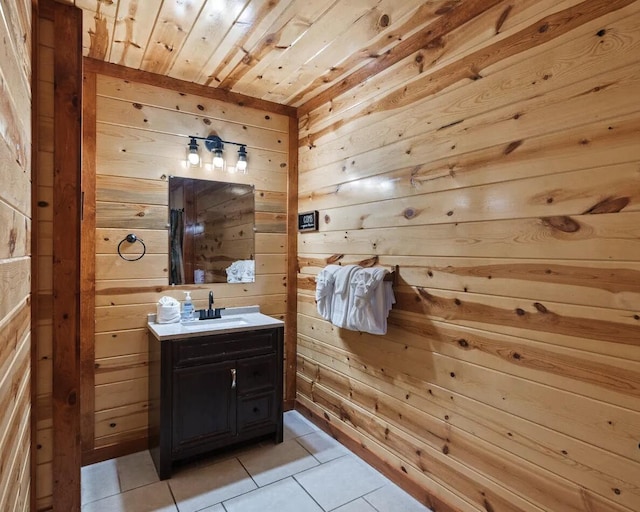 bathroom with wooden walls, tile patterned flooring, vanity, and wooden ceiling