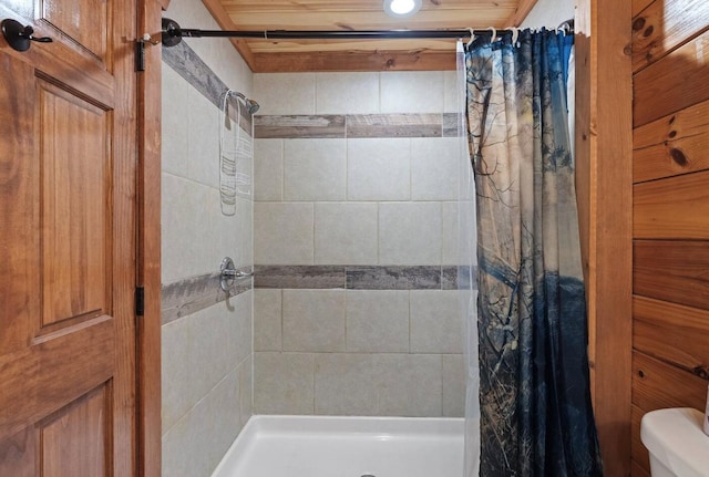 bathroom featuring curtained shower and toilet