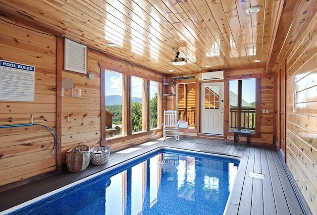 view of swimming pool featuring a wall mounted AC and a mountain view