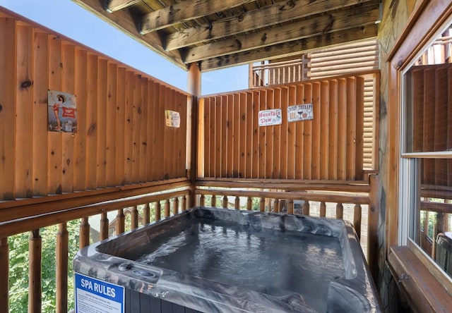 wooden terrace with a hot tub