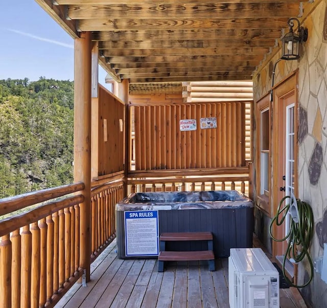 wooden terrace with a hot tub