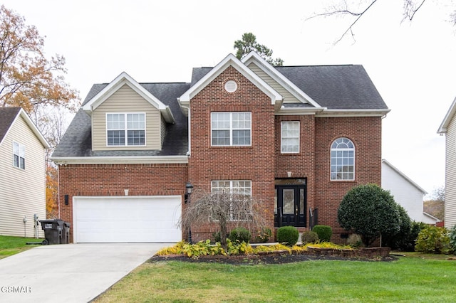 view of front of house with a garage and a front lawn