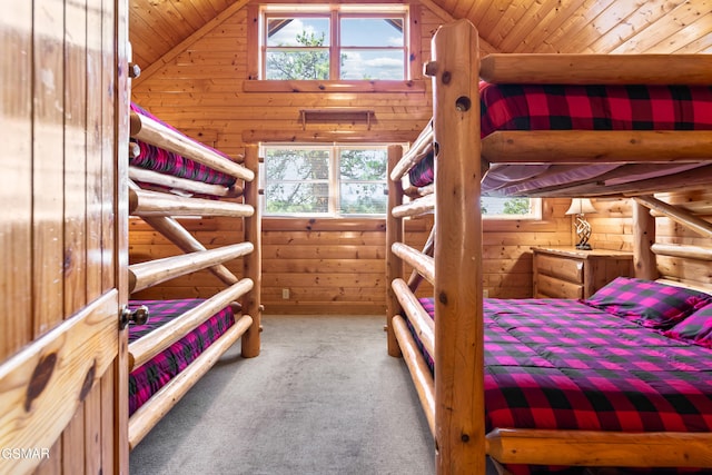 bedroom featuring carpet, vaulted ceiling, wooden ceiling, and wood walls