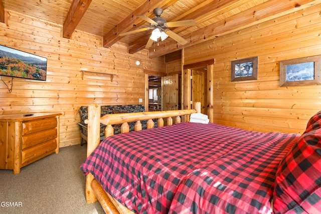 carpeted bedroom featuring wood walls, beamed ceiling, wooden ceiling, and ceiling fan