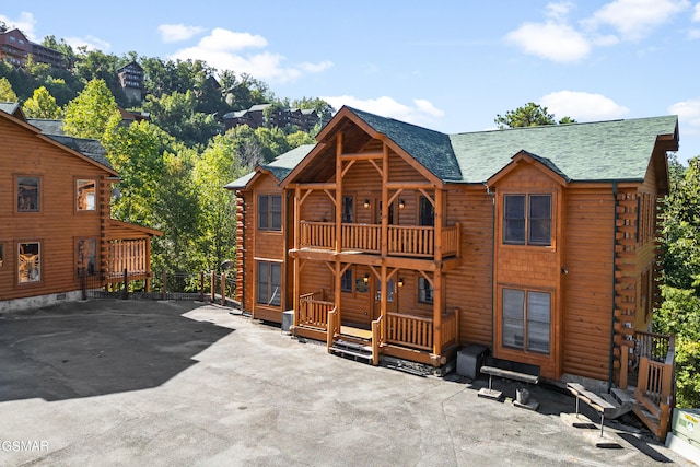 rear view of property with a balcony