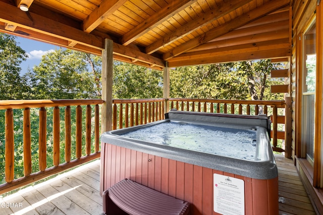 wooden terrace featuring a hot tub