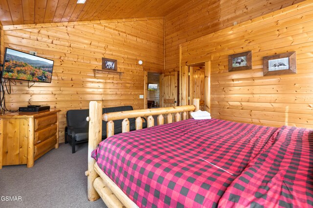 bedroom with carpet, wood ceiling, wooden walls, and vaulted ceiling