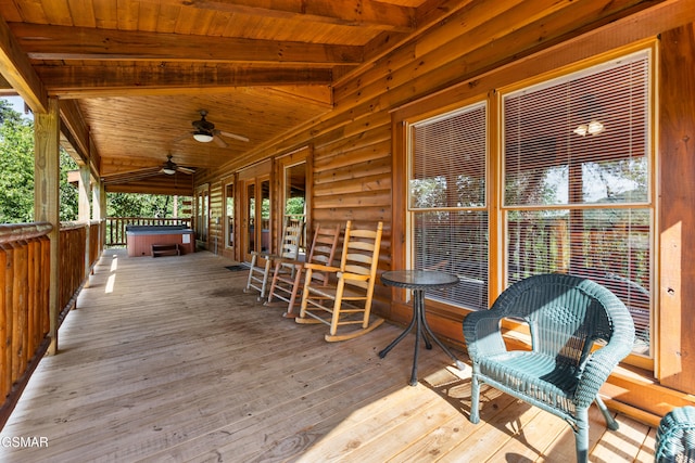 deck with ceiling fan and a hot tub