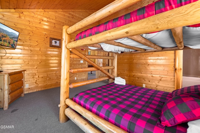 bedroom with carpet, vaulted ceiling, wooden ceiling, and wood walls