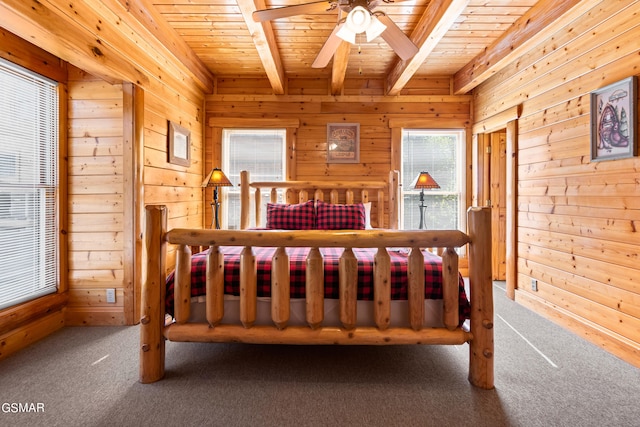 bedroom with beam ceiling, ceiling fan, wooden ceiling, wood walls, and carpet floors