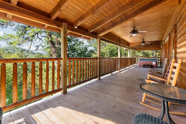 wooden deck featuring a hot tub and ceiling fan