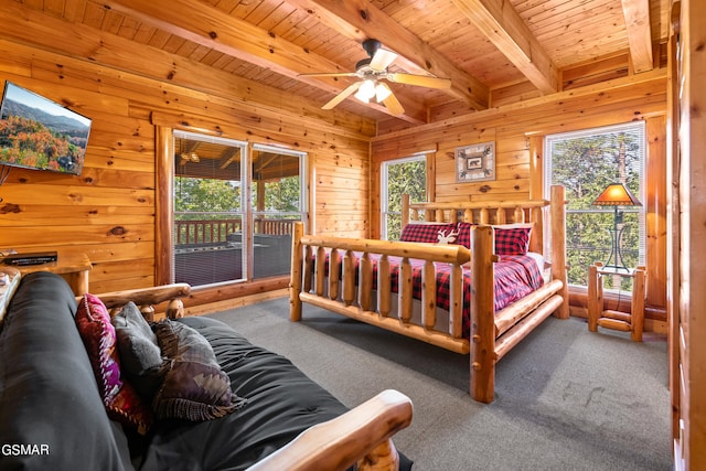 bedroom featuring beam ceiling, ceiling fan, wooden walls, carpet, and wood ceiling