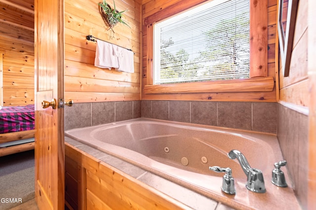 bathroom with a bath and wooden walls