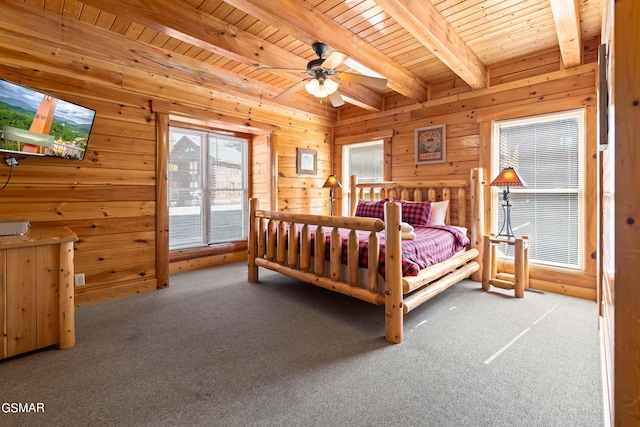 carpeted bedroom featuring beam ceiling, ceiling fan, wooden walls, and wood ceiling