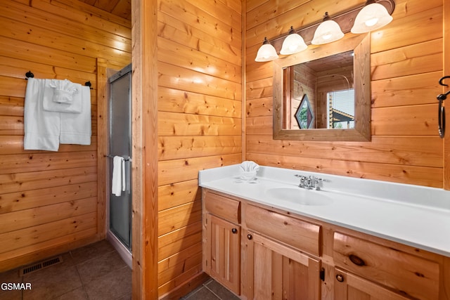 bathroom featuring wooden walls, tile patterned flooring, and walk in shower