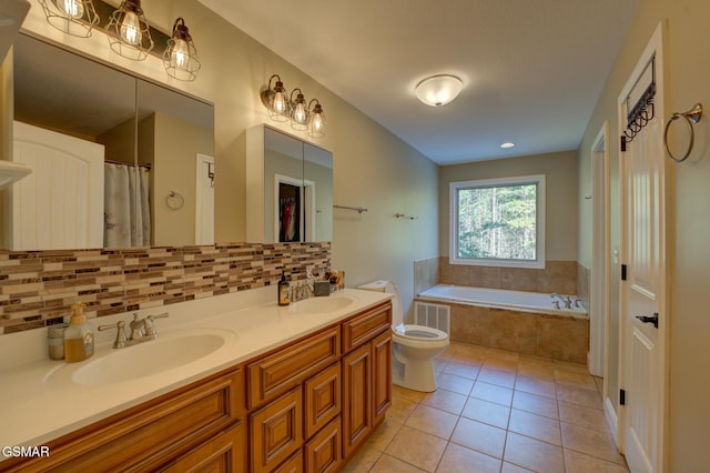 bathroom featuring tiled bath, toilet, tasteful backsplash, tile patterned flooring, and vanity