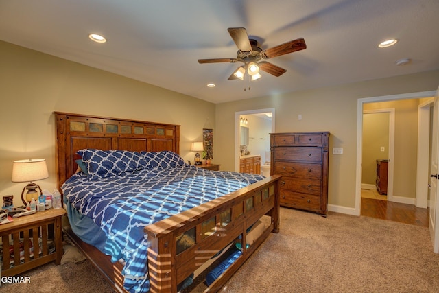 carpeted bedroom with ceiling fan and connected bathroom