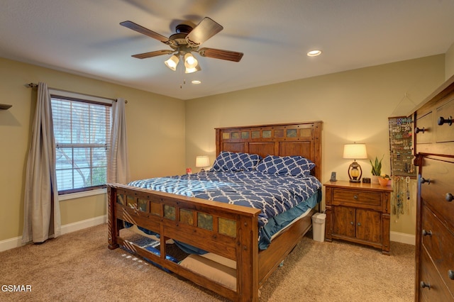 bedroom with ceiling fan and light colored carpet