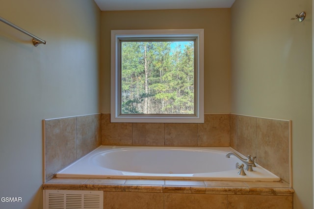 full bathroom featuring a garden tub and visible vents