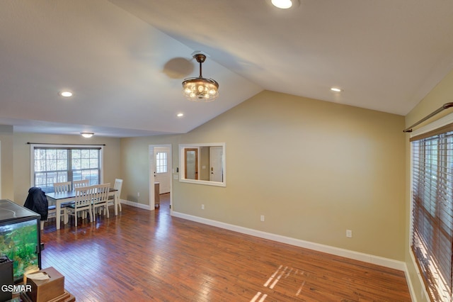 interior space with dark wood-type flooring and vaulted ceiling