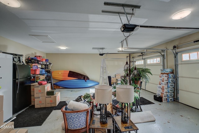 garage with freestanding refrigerator and a garage door opener