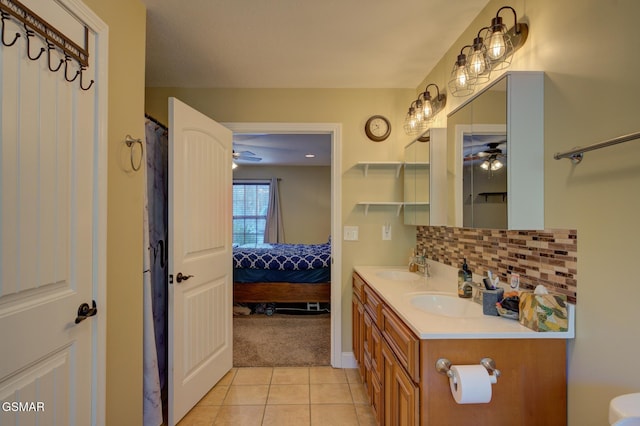 bathroom featuring tile patterned flooring, vanity, backsplash, and ceiling fan