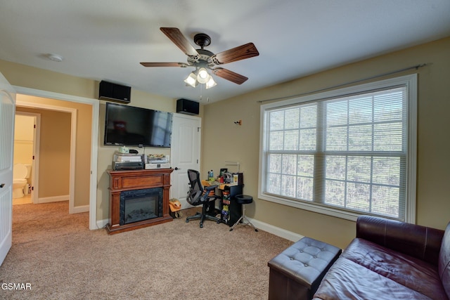 carpeted living room with ceiling fan