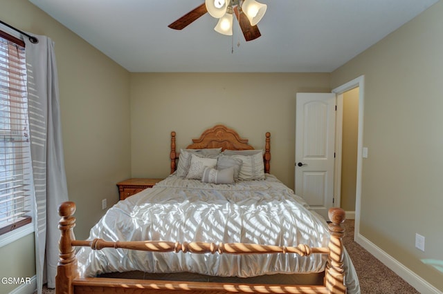 carpeted bedroom with ceiling fan and multiple windows