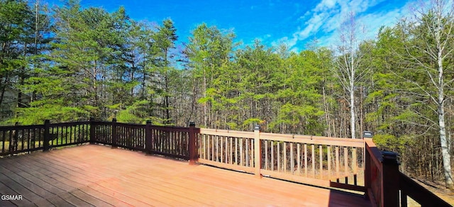 wooden deck with a view of trees