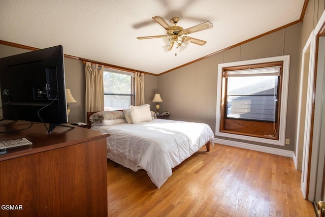 bedroom with ceiling fan, light hardwood / wood-style flooring, and vaulted ceiling