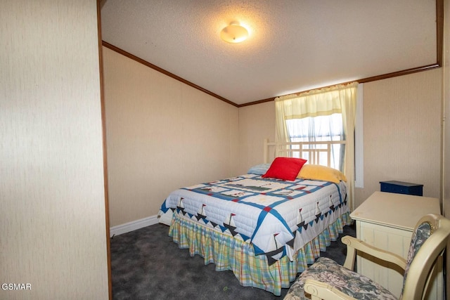 bedroom featuring dark colored carpet and a textured ceiling