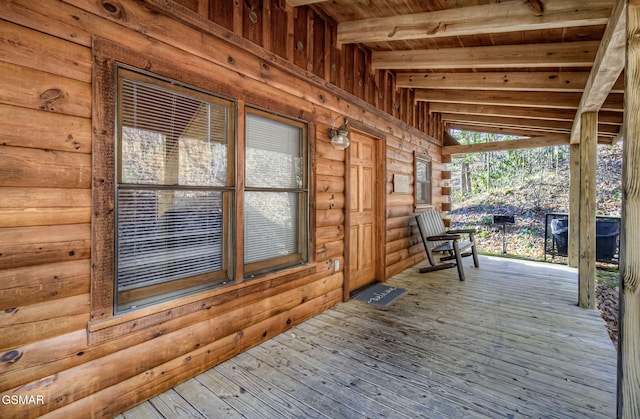 wooden terrace featuring covered porch