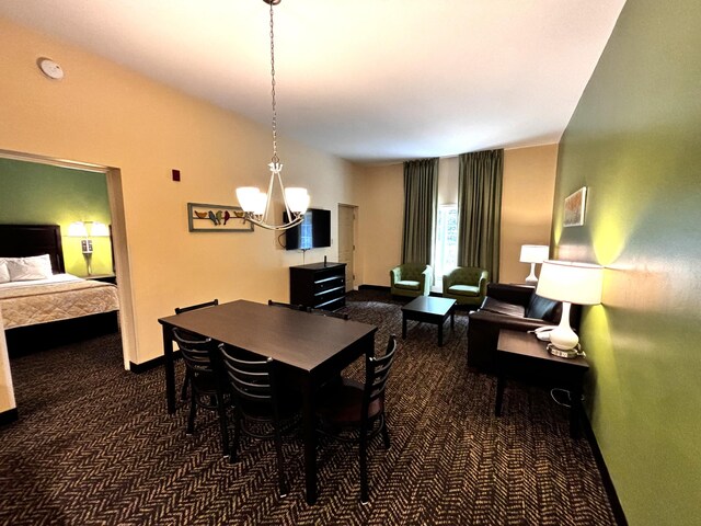 carpeted dining space with a chandelier