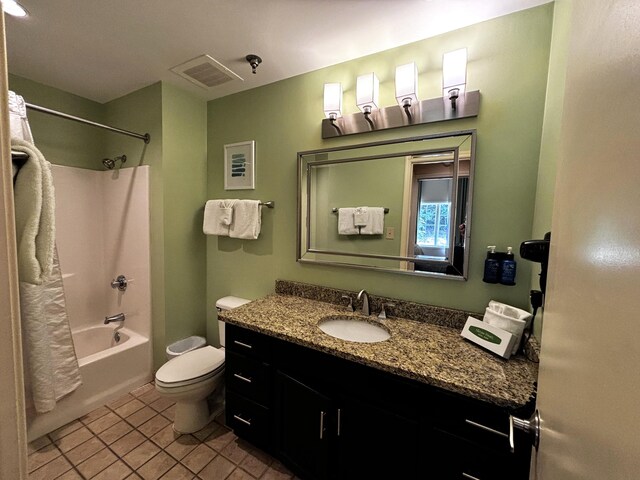 full bathroom featuring tile patterned flooring, vanity, toilet, and shower / tub combo