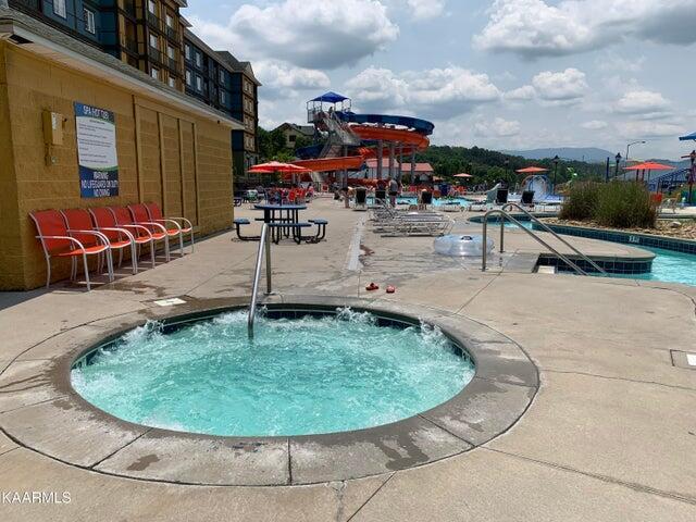 view of swimming pool featuring a community hot tub