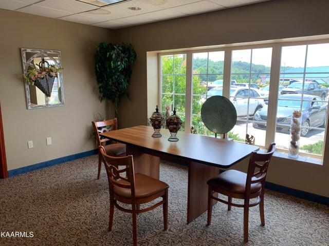 dining area with carpet and a paneled ceiling