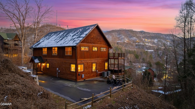 view of property exterior with a mountain view and central AC unit