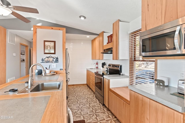 kitchen featuring visible vents, lofted ceiling, appliances with stainless steel finishes, light floors, and under cabinet range hood