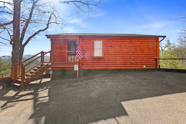 view of front of home with log veneer siding